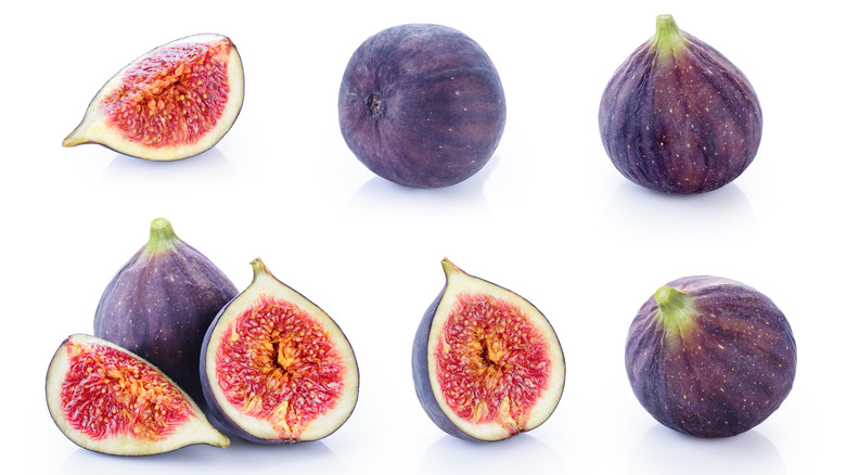 Cut and whole figs on white background