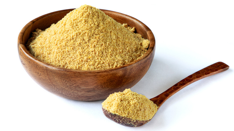 Golden flaxseed in wooden bowl and spoon