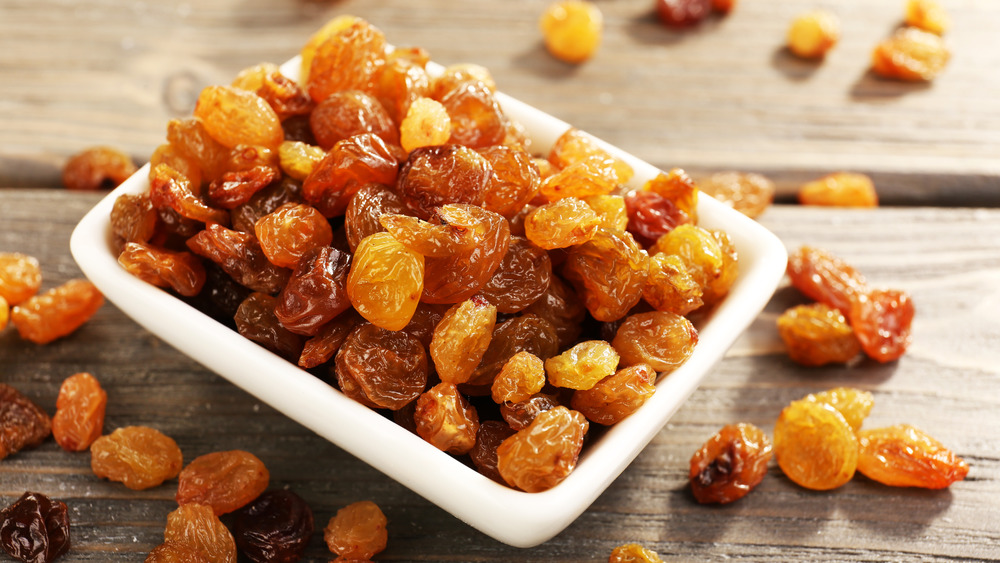 Golden raisins in a white container