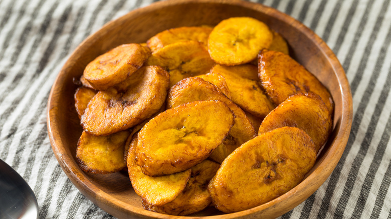 Fried plantain chips in a wood bowl