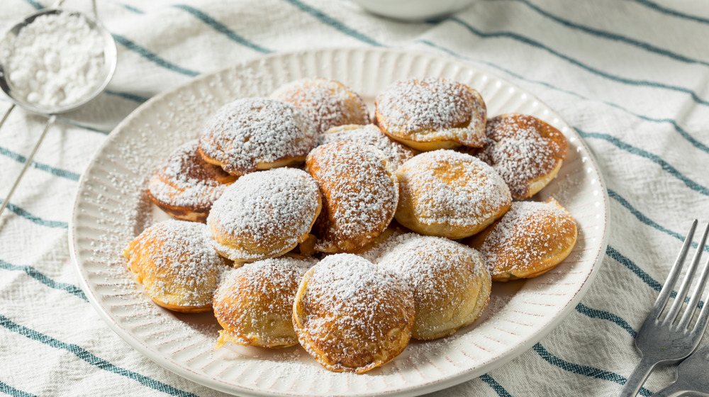 A white plate with poffertjes