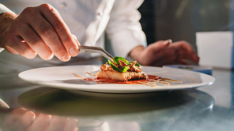 Chef plating dish in restaurant