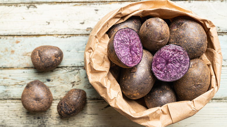 purple potatoes in brown paper bag