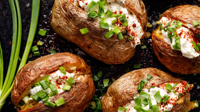 Baked potatoes with scallions and sour cream