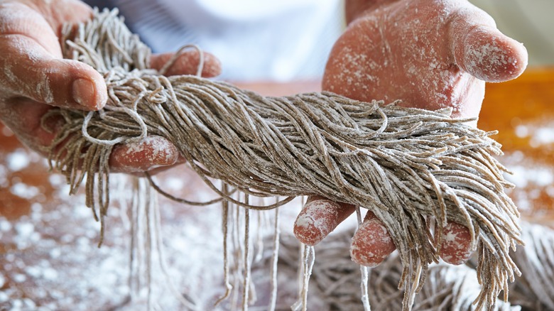 fresh soba noodles in hands