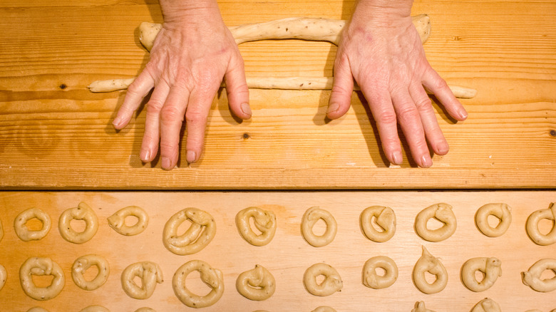 hands rolling homemade taralli