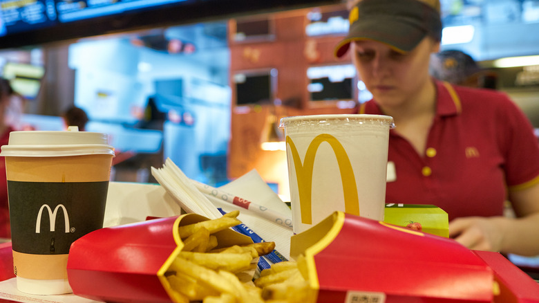 Food on tray in front of McDonald's worker