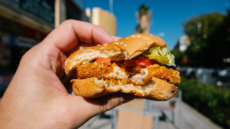 Handheld fast food chicken sandwich