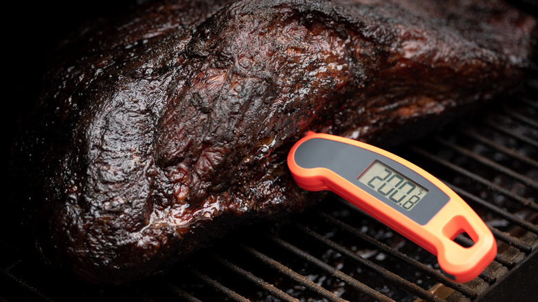 Cooked meat with a thermometer stuck in it