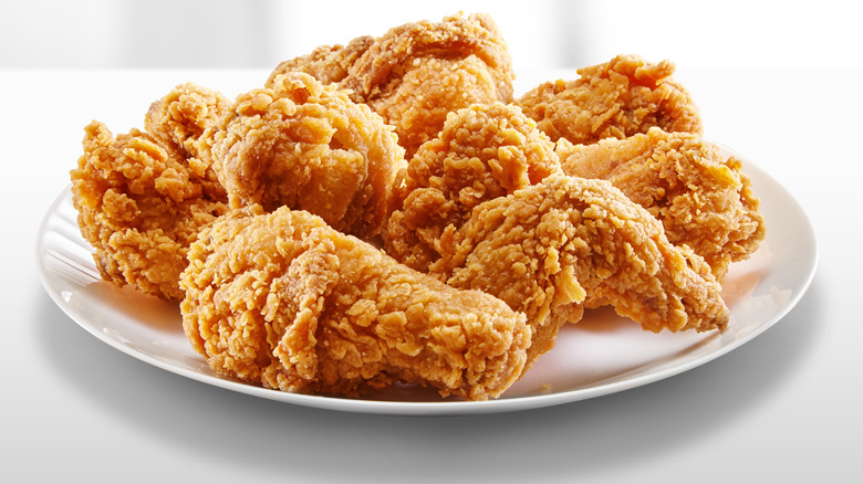 Multiple pieces of fried chicken on a white plate