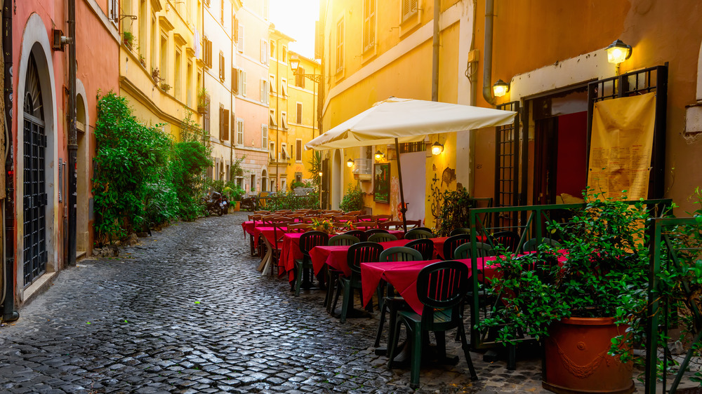 Rome street with tables and chairs