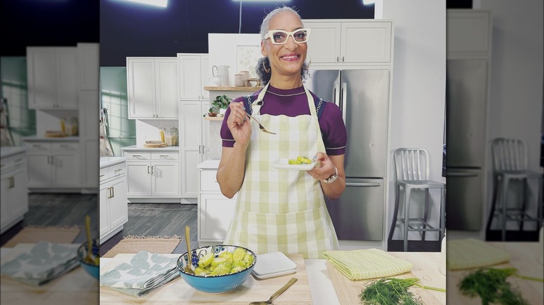 Carla Hall cooking in kitchen