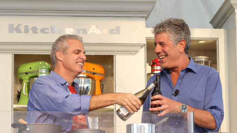 Ripert and Bourdain toasting drinks