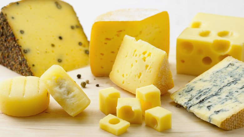 cheeses on wooden board