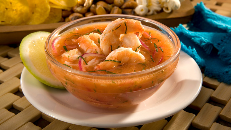 shrimp ceviche in glass bowl on white plate