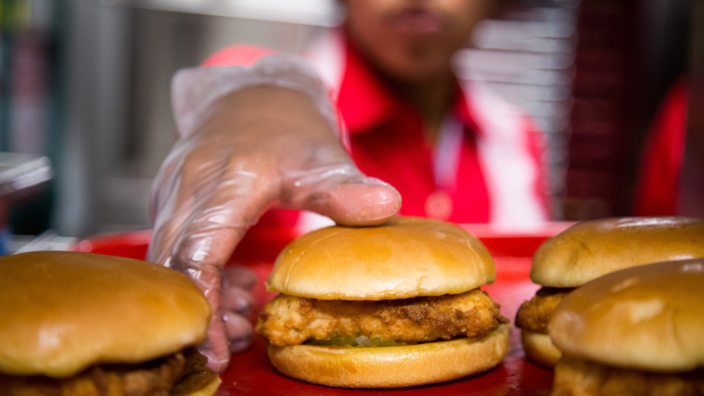 Chick-fil-A employee grabbing chicken sandwich