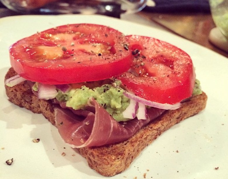 oasted bread with prosciutto, avocado, tomato, and red onion