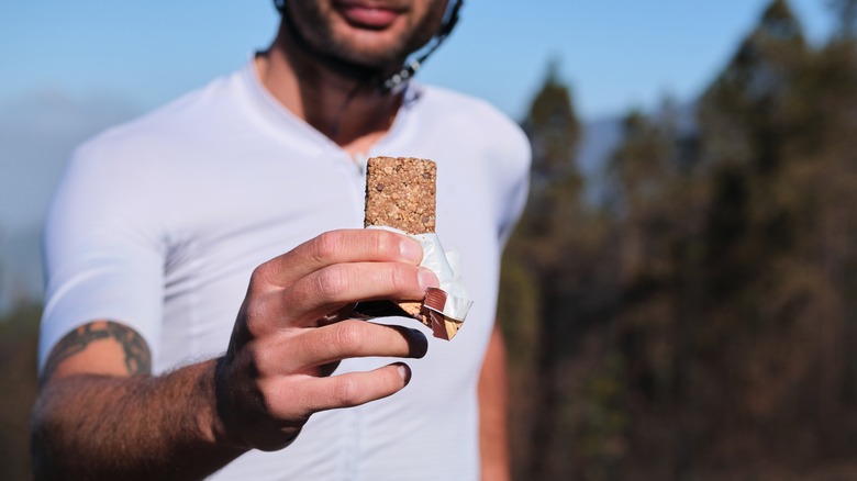 man holding protein bar