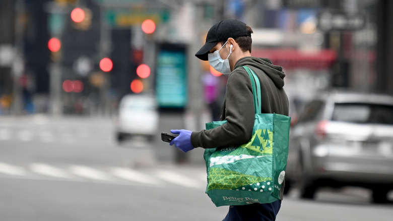 Man with a reusable Whole Foods bag