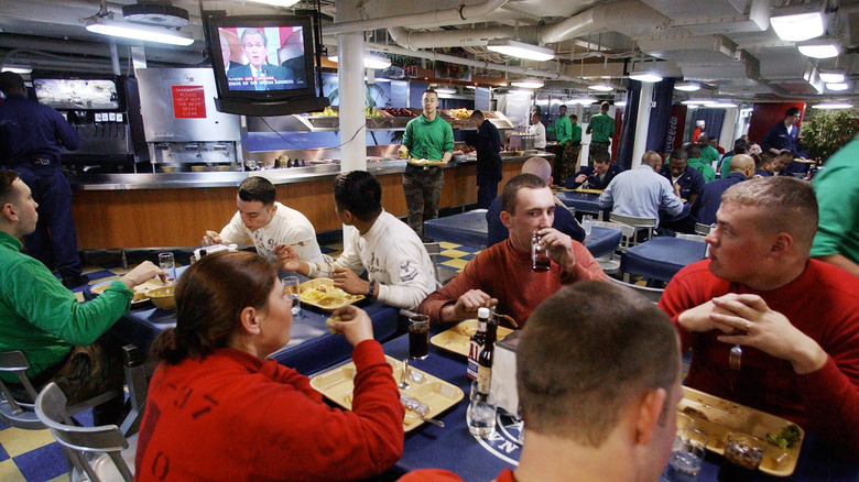 Navy sailors eating with buffet line