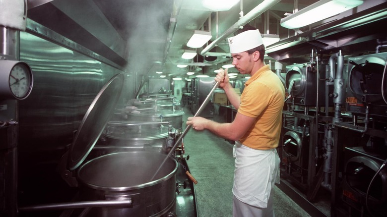 US Navy culinary specialist stirring a giant pot