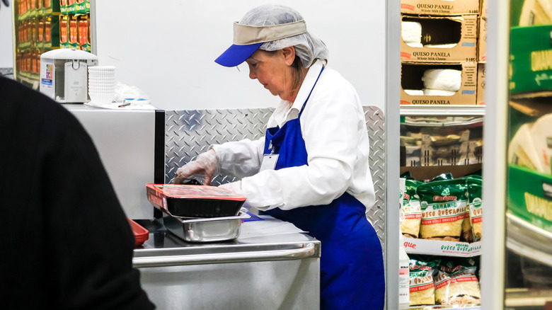 Woman working at Costco sample station