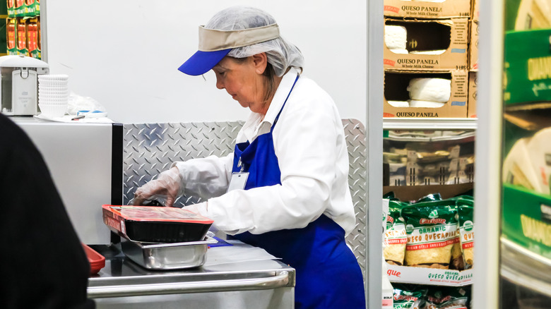 costco employee prepares samples