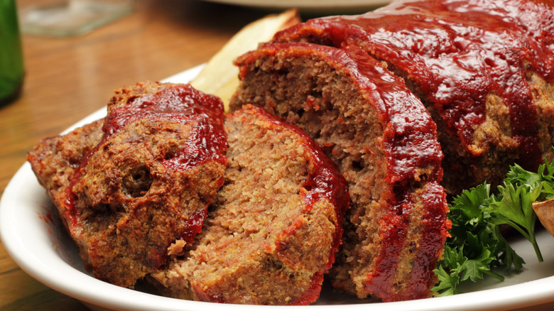 Meatloaf on white plate with parsley