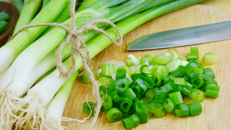 scallions on cutting board 