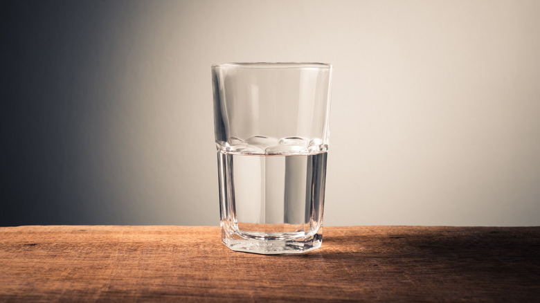 glass of water on wooden table 