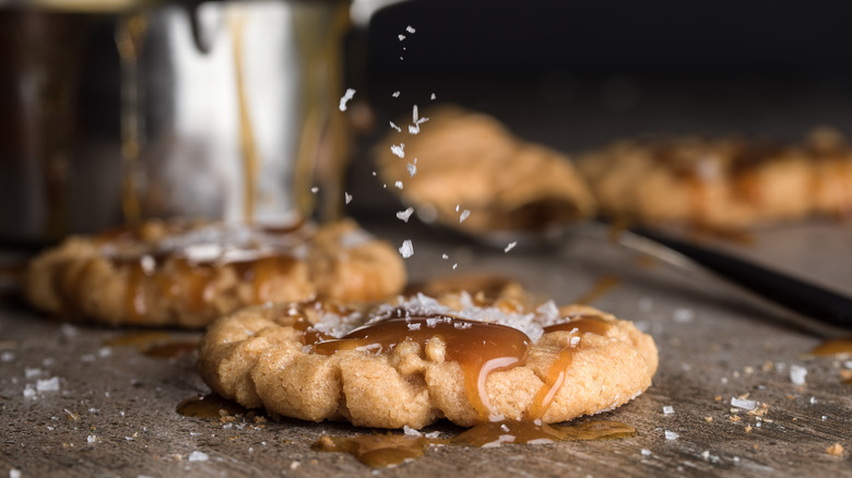 sprinkling salt on caramel cookies