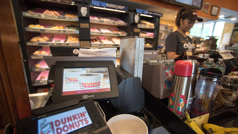 Dunkin' employee at register