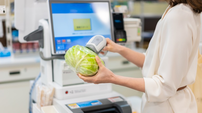 Woman scanning head of lettuce