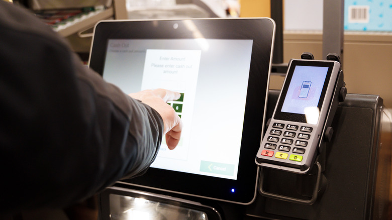 person entering numbers self checkout