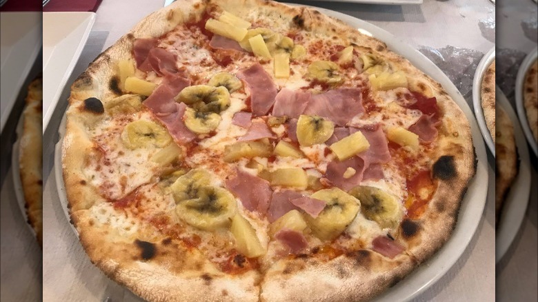 pizza with banana, pineapple, and ham