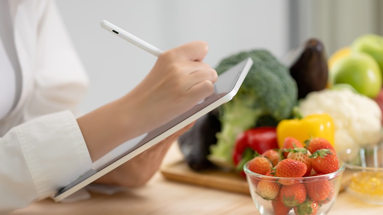 Doctor with tablet and food