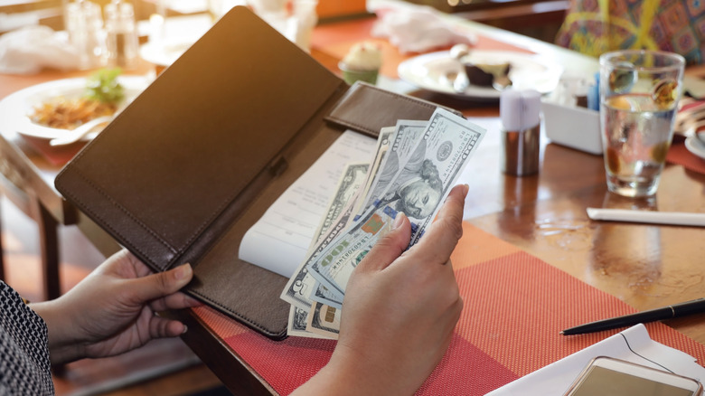 paying restaurant bill with cash