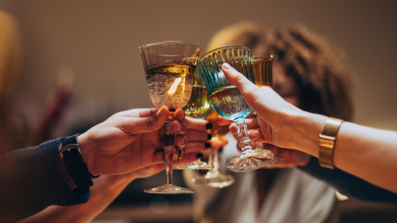 People toasting drinks