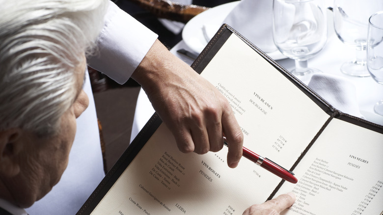 Waiter making menu recommendations