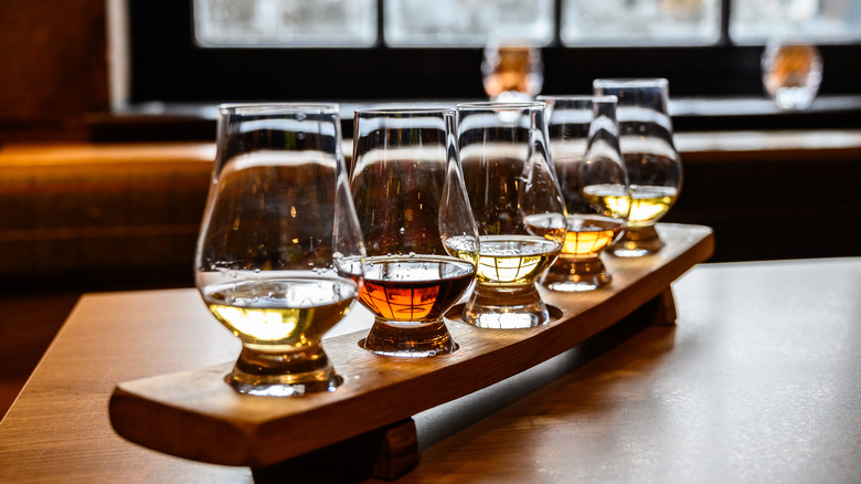 five glasses of whiskey lined up for a tasting