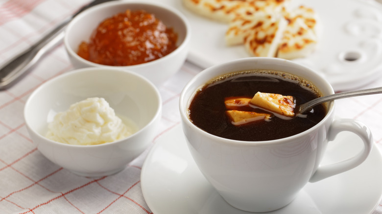 bread cheese in cup of coffee