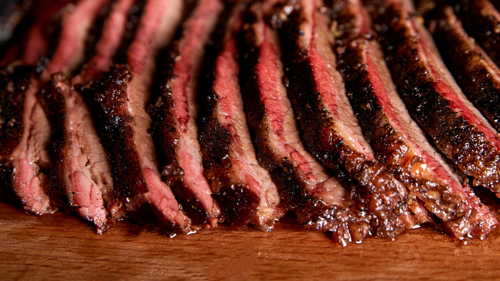 Chef cuts up meat on a cutting board with a sharp knife Stock Photo by  wirestock