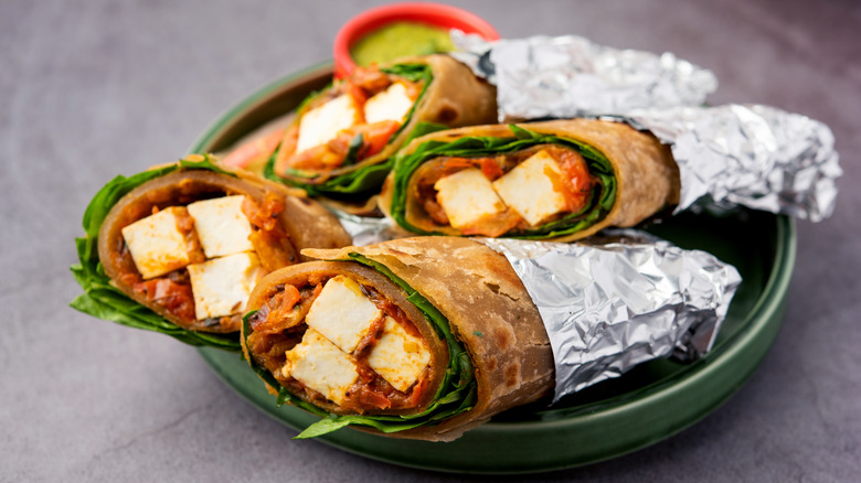 Kaathi rolls wrapped in foil on plate