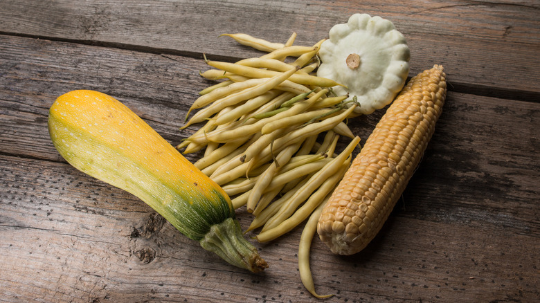 corn, beans, and squash on a table