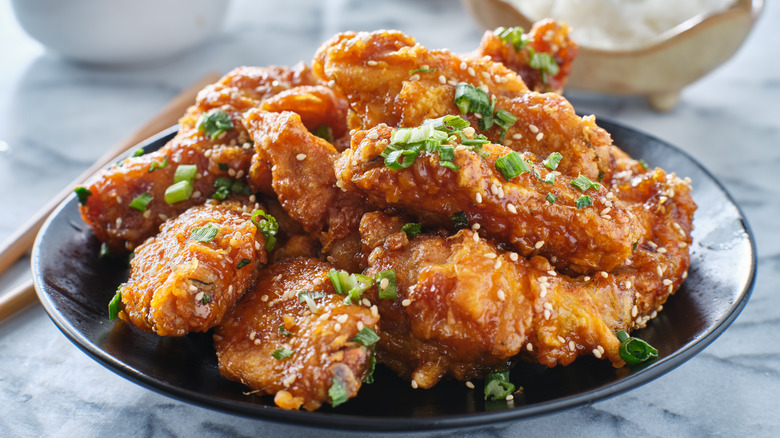 Korean fried chicken wings on black plate