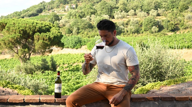 Gabe Bertaccini drinking glass of wine in Tuscany