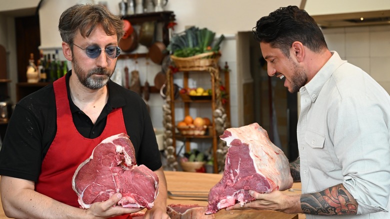 Gabe Bertaccini and butcher holding meat