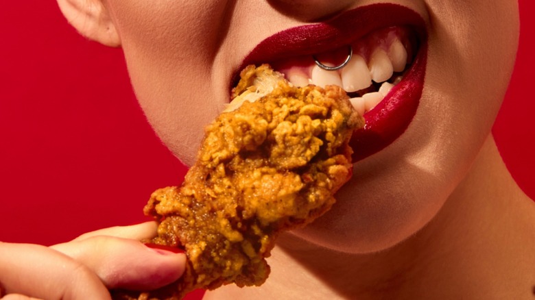 woman eating fried chicken