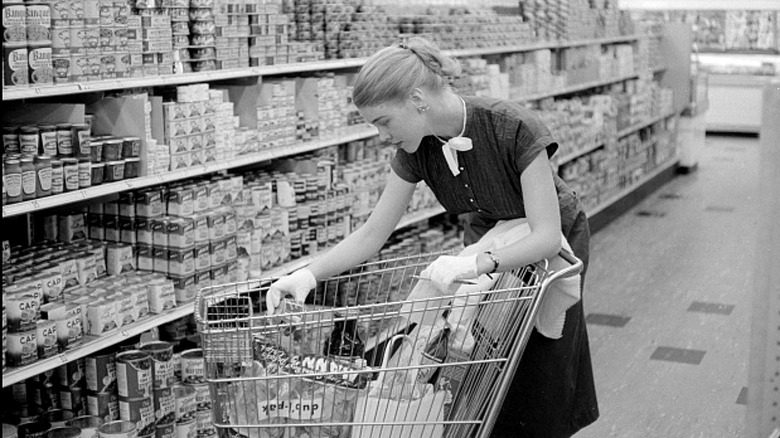 Well-dressed woman reading food lable