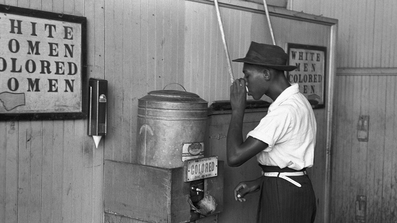 man drinking from "colored" jug